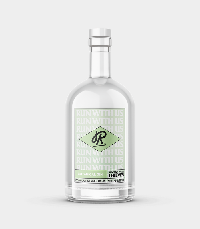 A clear bottle containing transparent liquid, presumably the botanical gin, with a label that includes green botanical illustrations and the brand name 'R+P' displayed prominently.