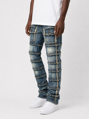 FWRD Patchwork True Stacked Denim jeans in light tint with multicolored patchwork design and stacked fit.