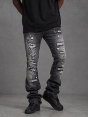 FWRD Worn Down Stacked Flare Denim in washed black, showcasing distressed denim fabric and high-waisted, flared design.