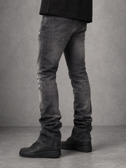 FWRD Worn Down stacked flare denim jeans in washed black with a distressed, faded look and high-rise fit.