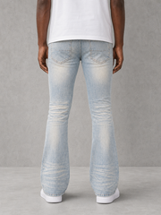 Blue denim flared pants from KDNK's Patch & Print collection, featuring a stylish, high-waisted design and patchwork details.