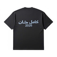 Black KML 'SCRIPTURE' heavyweight T-shirt with bold white lettering, casual fit, and comfortable fabric.
