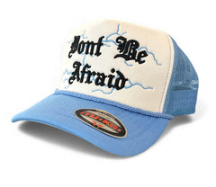 White and sky blue MUKA Don’t Be Afraid trucker hat with mesh back and adjustable strap, casual accessories for outdoor wear.