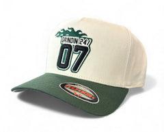 MUKA Grindin 24/7 snapback hat in ivory and dark green, adjustable accessories hat with flat brim and embroidered logo.