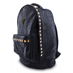Black crocodile-embossed studded backpack from Mint Accessories, showing side view with adjustable straps and textured surface.