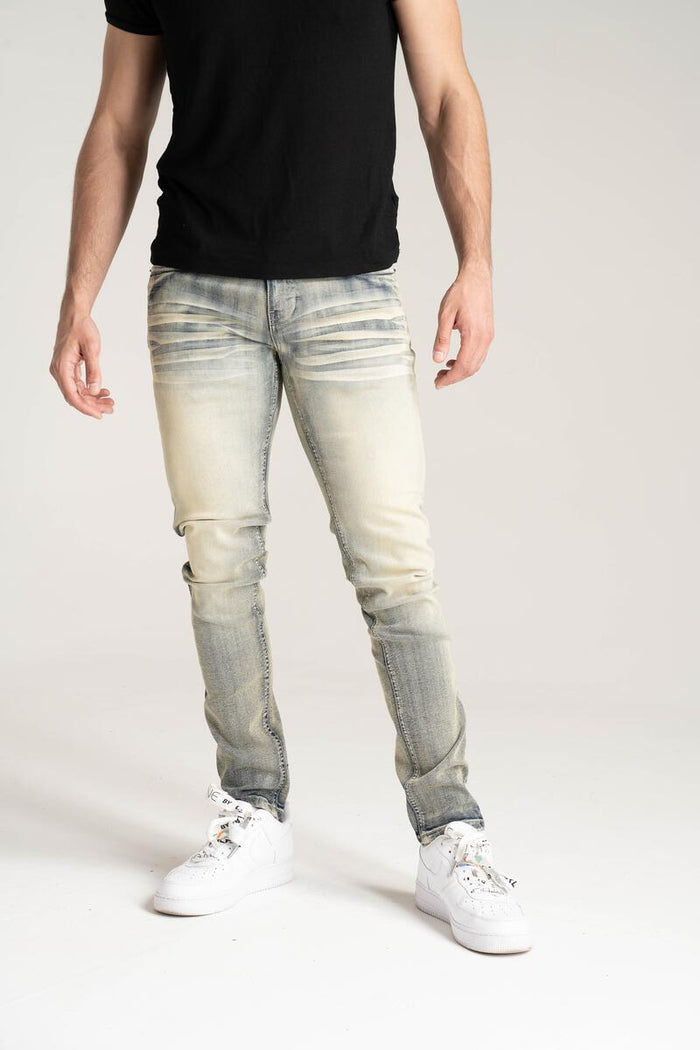 Spark Stretch Basic Denim in Rustic Blue, showing fitted mid-rise jeans with classic five-pocket design and slight fading.